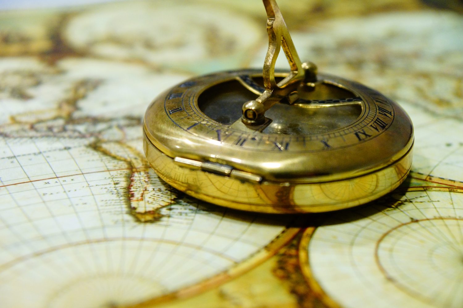 Antique compass resting on a map, a symbol of direction and insight